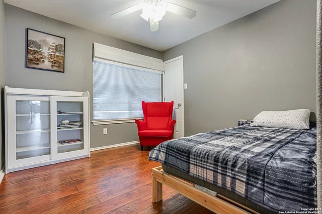 a bedroom with a bed and wooden floor
