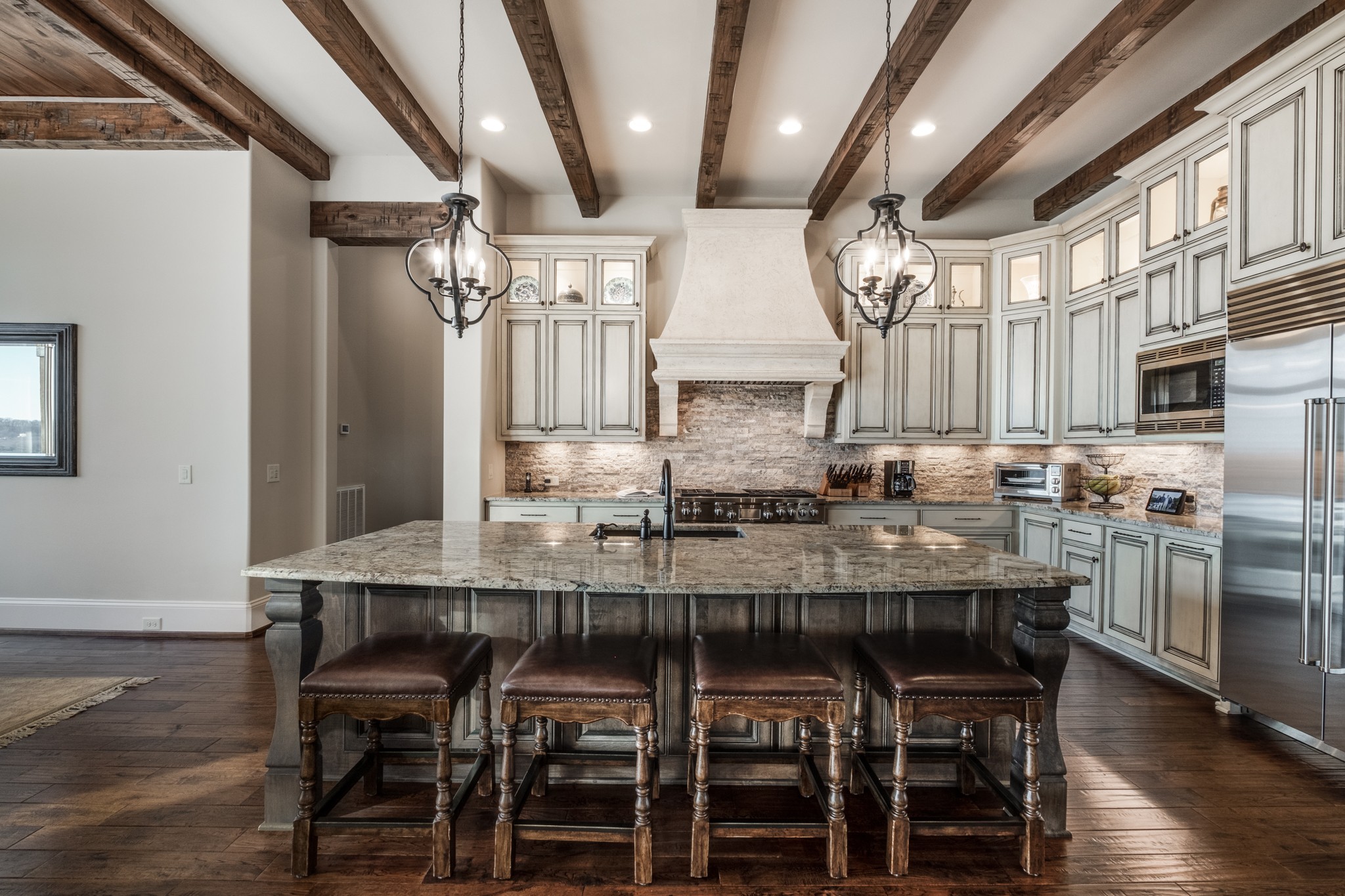 505 Legends Ridge Court Franklin, TN 37069 - Photo 13 of 70 a kitchen with stainless steel appliances kitchen island granite countertop a table chairs sink and cabinets