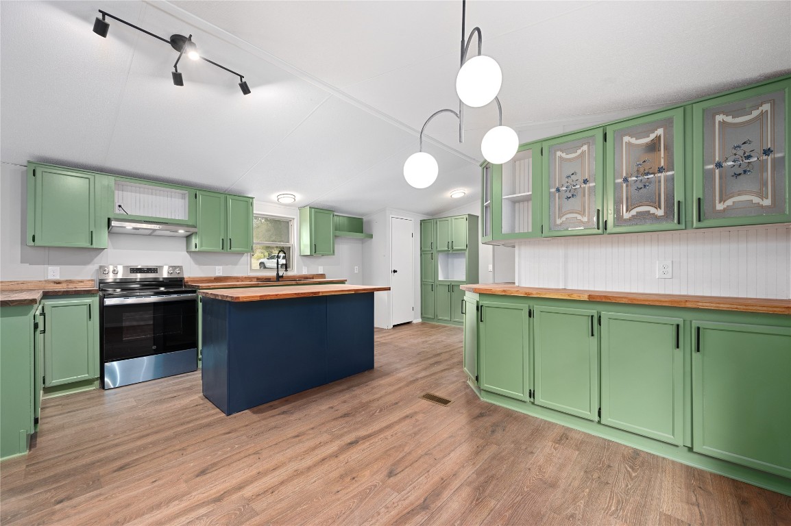 20123 McShepherd Road Georgetown, TX 78626 - Photo 3 of 27 a kitchen with stainless steel appliances kitchen island granite countertop a sink cabinets and wooden floor