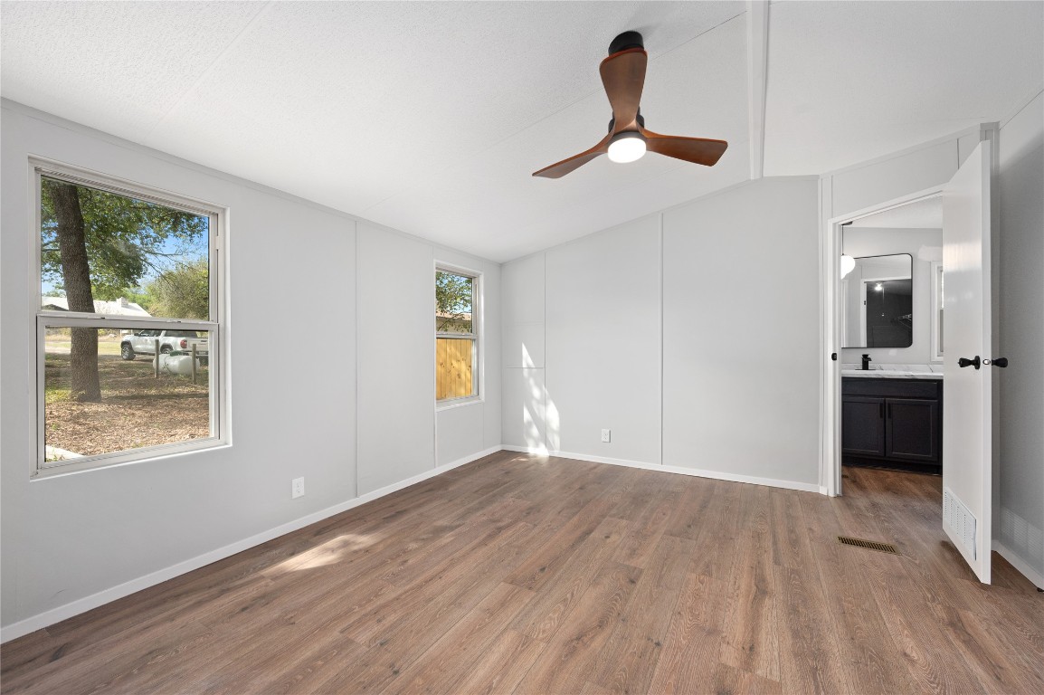 20123 McShepherd Road Georgetown, TX 78626 - Photo 9 of 27 a view of an empty room with window and wooden floor