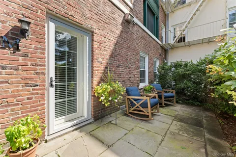 a view of backyard with outdoor seating and a potted plant