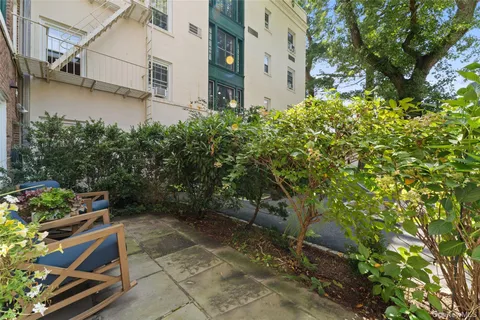 a backyard of a house with table and chairs