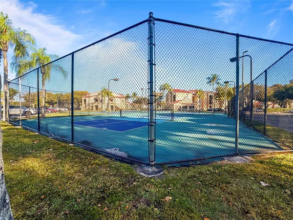 a view of swimming pool with palm trees
