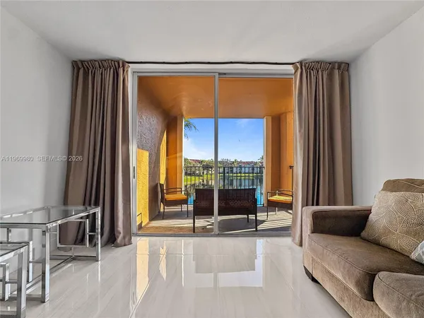 a living room with a large window and a glass door