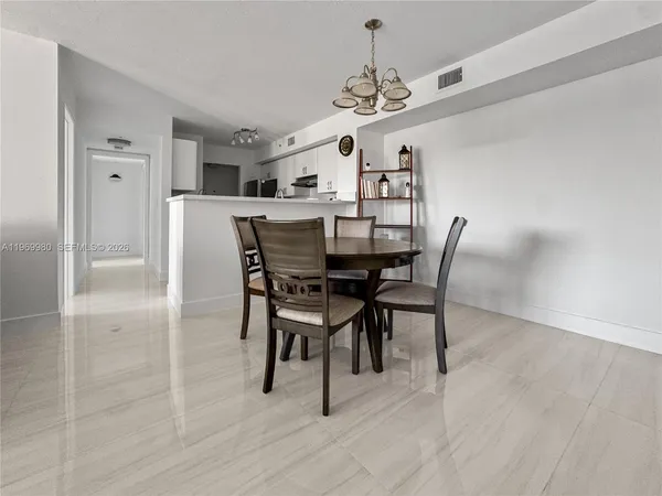 a view of a dining room with furniture and chandelier