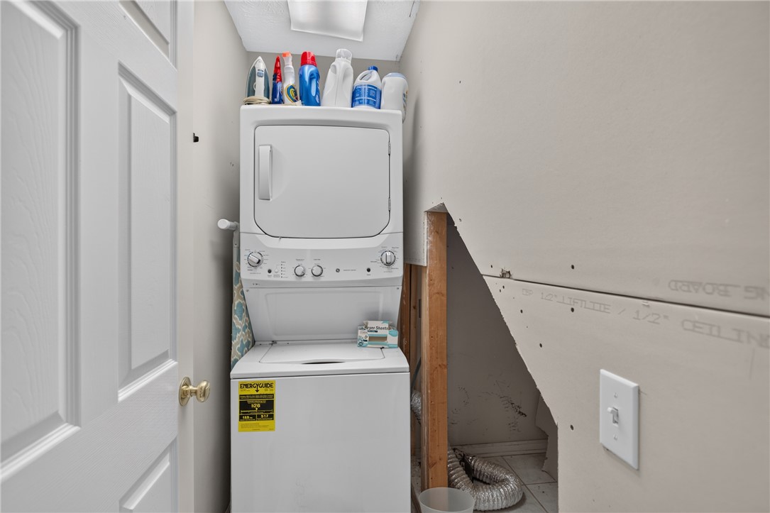 612 Providence Point Drive Seneca, SC 29678 - Photo 19 of 43 A compact laundry nook offers stacked washer and dryer for efficient utility.
