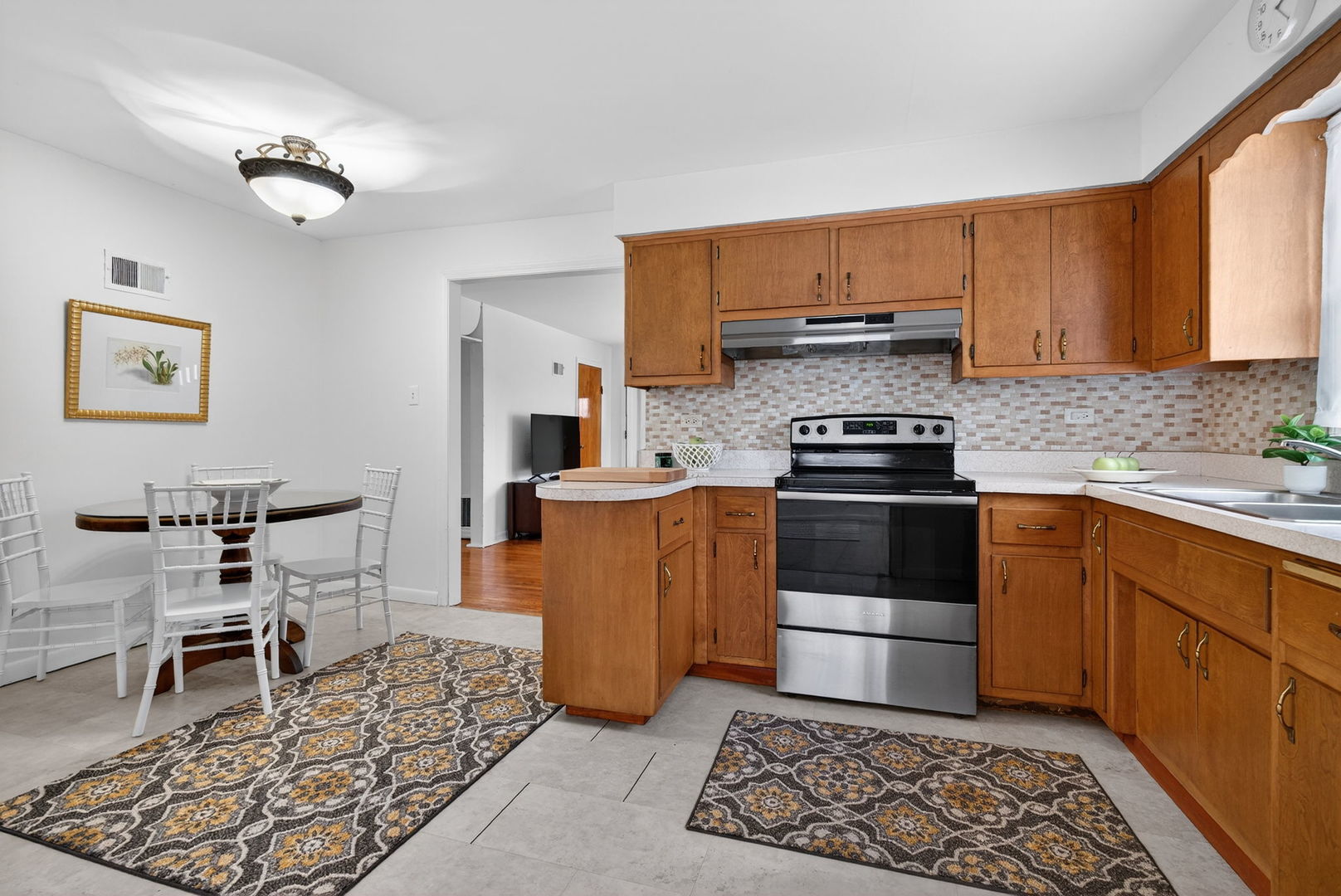12620 Irving Avenue Blue Island, IL 60406 - Photo 14 of 37 a kitchen with stainless steel appliances granite countertop a stove a sink dishwasher and a refrigerator