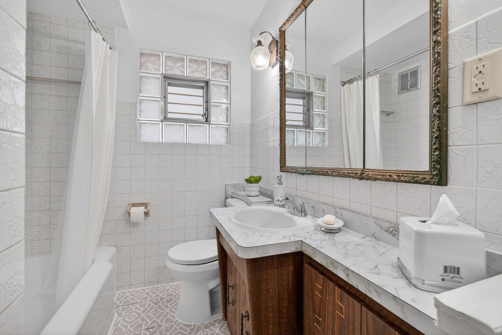 12620 Irving Avenue Blue Island, IL 60406 - Photo 24 of 37 a bathroom with a granite countertop sink a toilet and a mirror