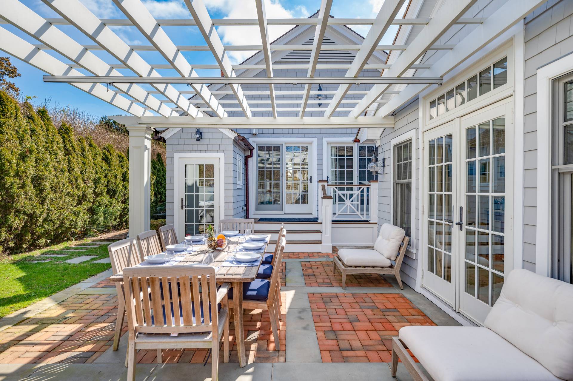 5 Ridge Drive Sag Harbor, NY 11963 - Photo 19 of 27 a view of a patio with couches table and chairs and potted plants