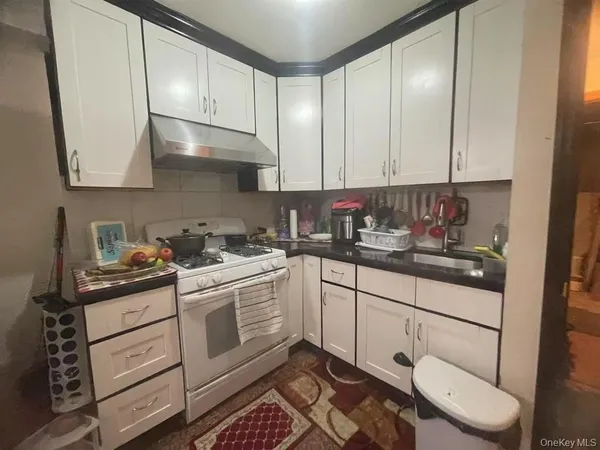 a kitchen with a white cabinets and white appliances
