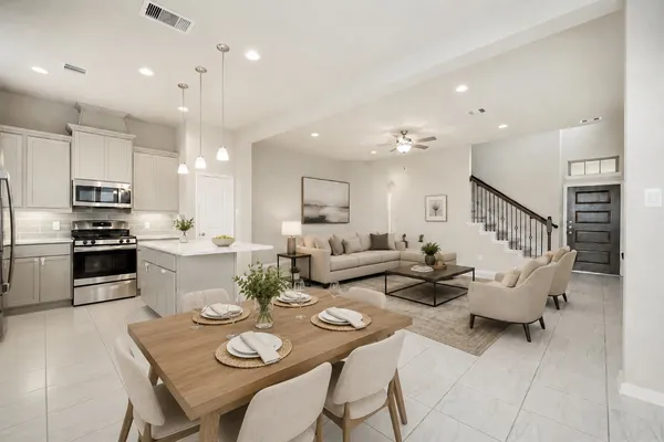 a living room with furniture kitchen and a table