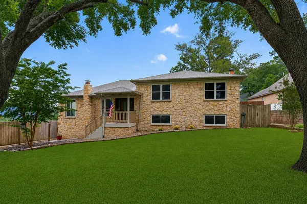a front view of house with yard and green space