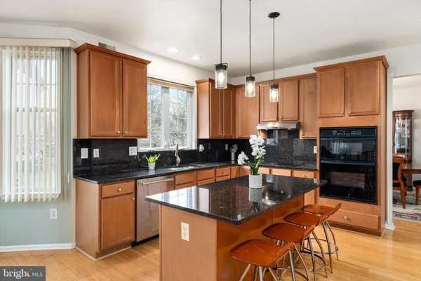 a kitchen with granite countertop a sink a counter top space appliances and cabinets