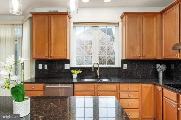 a kitchen with granite countertop a stove a sink and a granite counter tops