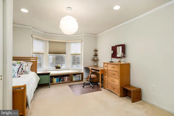 a bedroom with bed and a large window