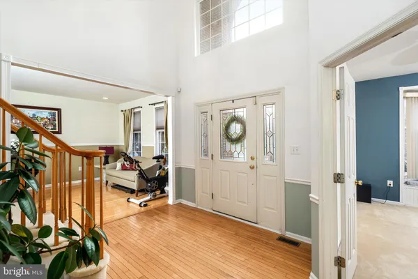 a view of a bedroom with wooden floor and windows