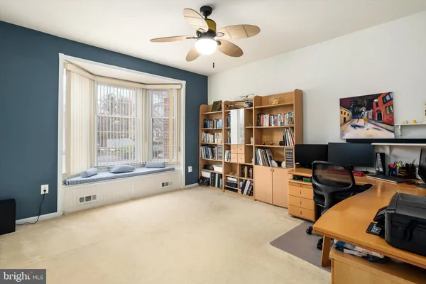 a bedroom with furniture and a large window