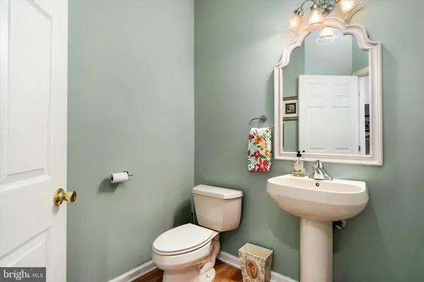 a bathroom with a sink a mirror and a toilet