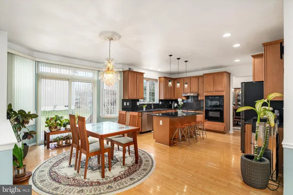 a dining room with furniture kitchen view and a chandelier