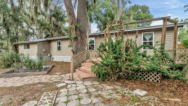 a backyard of a house with plants and trees
