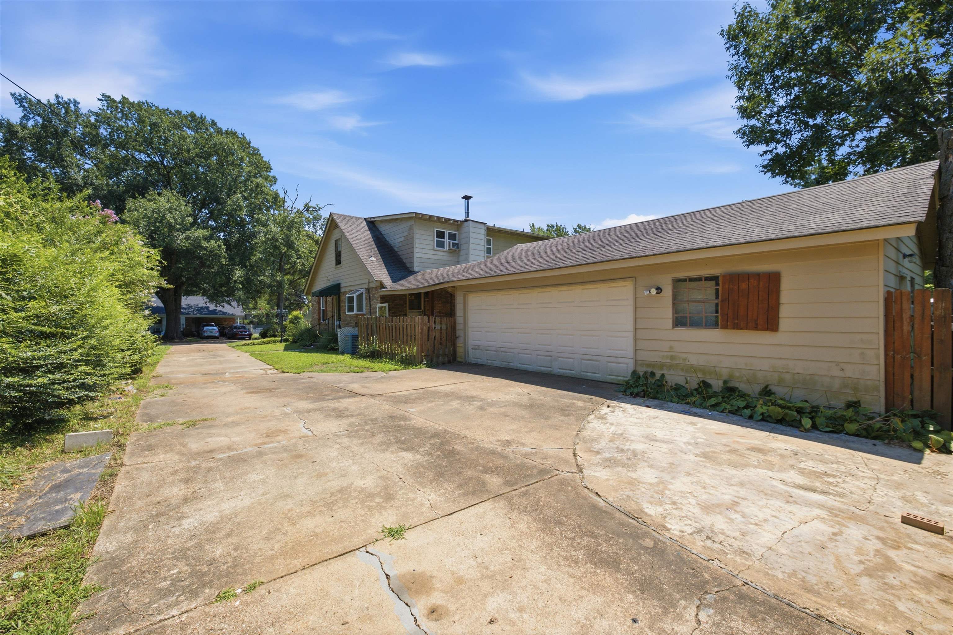 3007 Ruskin Road Bartlett, TN 38134 - Photo 3 of 37 Long concrete driveway leading to an attached garage with a tan overhead door