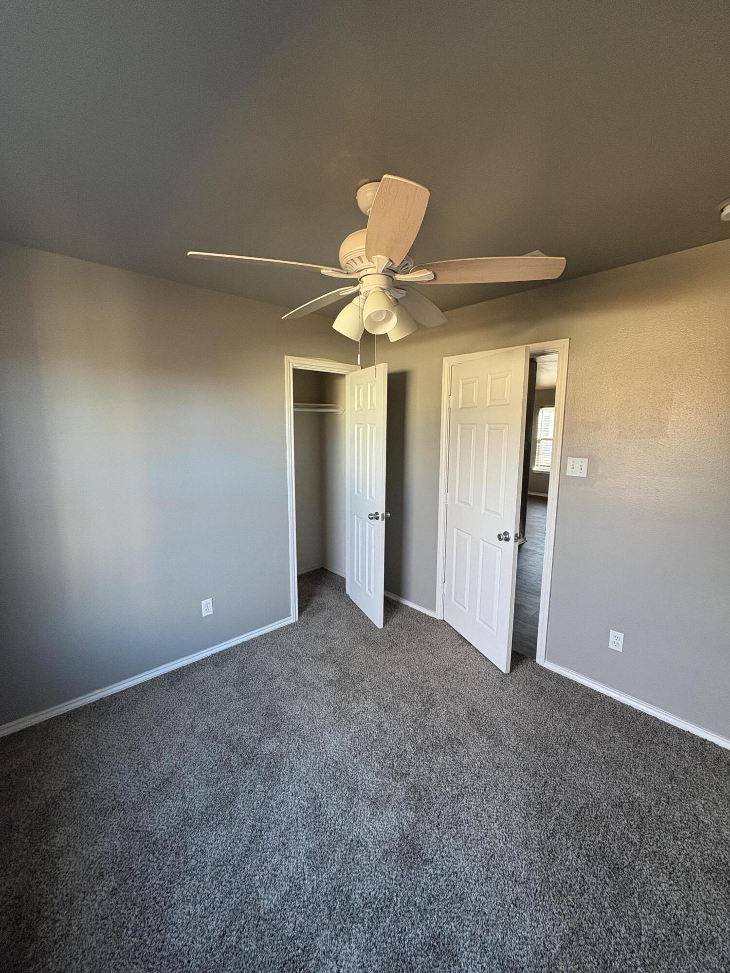 4425 Jarvis Street Lubbock, TX 79416 - Photo 11 of 16 an empty room and chandelier fan