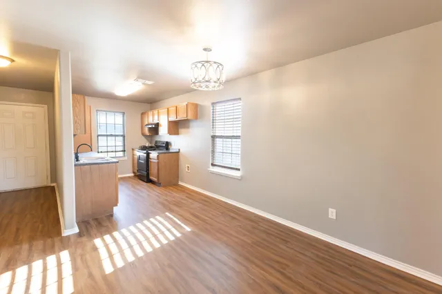 a view of a kitchen with wooden floor and a kitchen