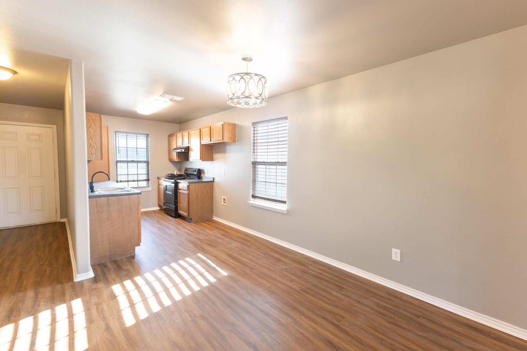 4425 Jarvis Street Lubbock, TX 79416 - Photo 3 of 16 a view of a kitchen with wooden floor and a kitchen