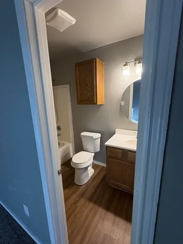 a bathroom with a toilet and a mirror