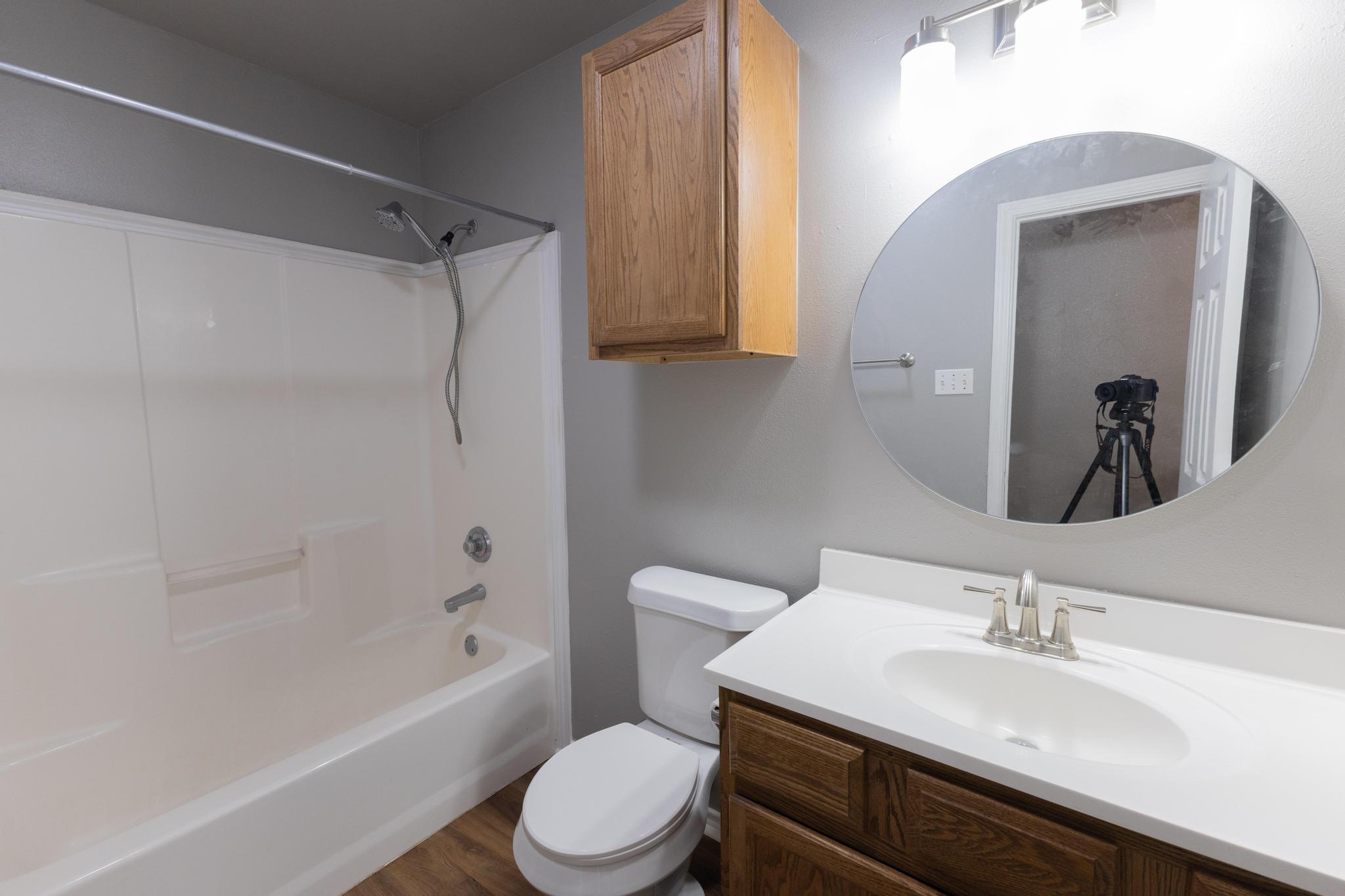 4425 Jarvis Street Lubbock, TX 79416 - Photo 7 of 16 a bathroom with a sink a toilet and a bathtub