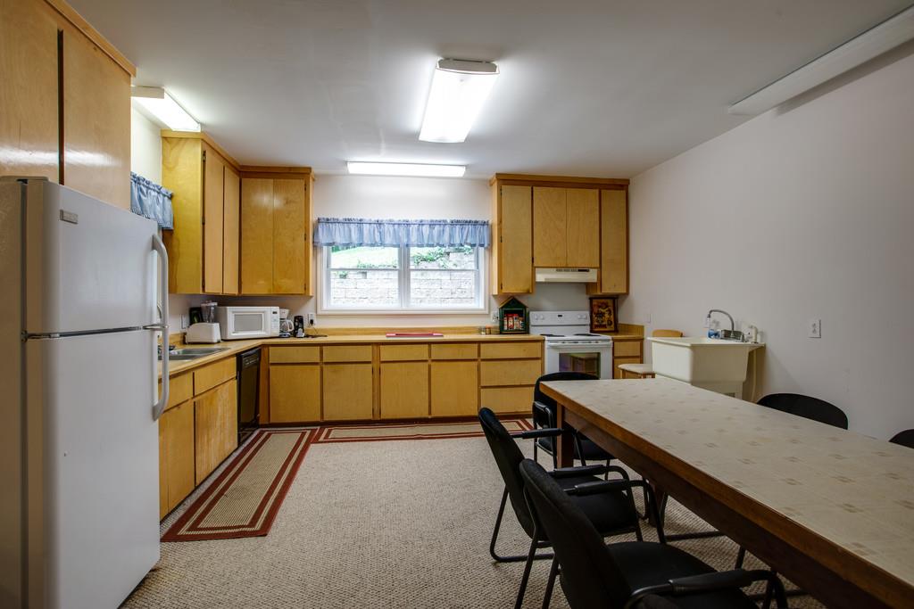 3340 Blazer Road Franklin, TN 37064 - Photo 21 of 29 a kitchen with a table chairs refrigerator and microwave