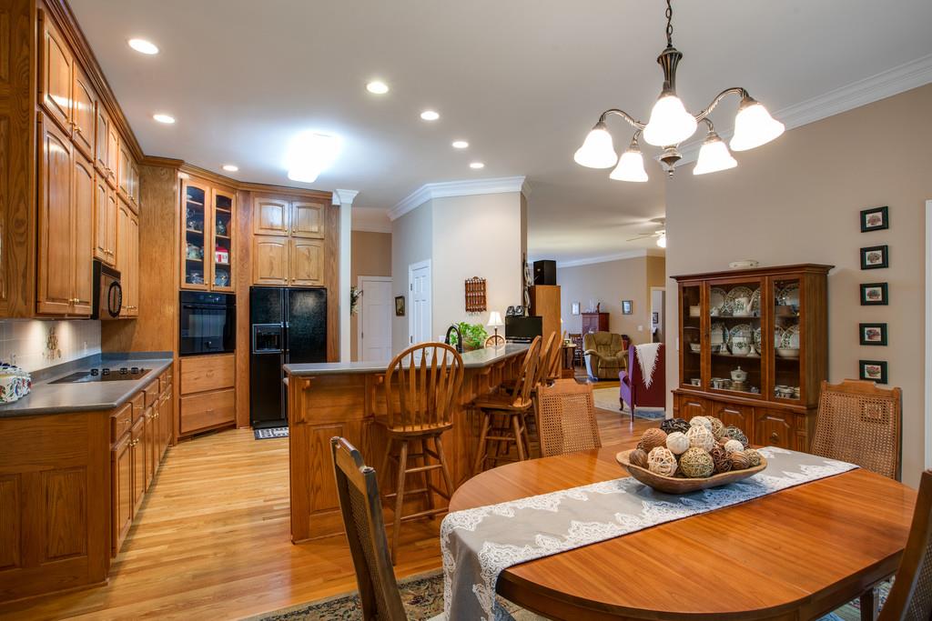 3340 Blazer Road Franklin, TN 37064 - Photo 10 of 29 a view of a dining room with furniture a kitchen and wooden floor