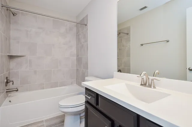 a bathroom with a sink a mirror and shower