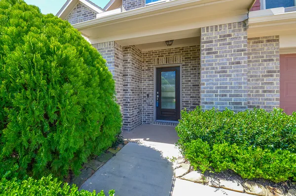 a front view of a house with garden