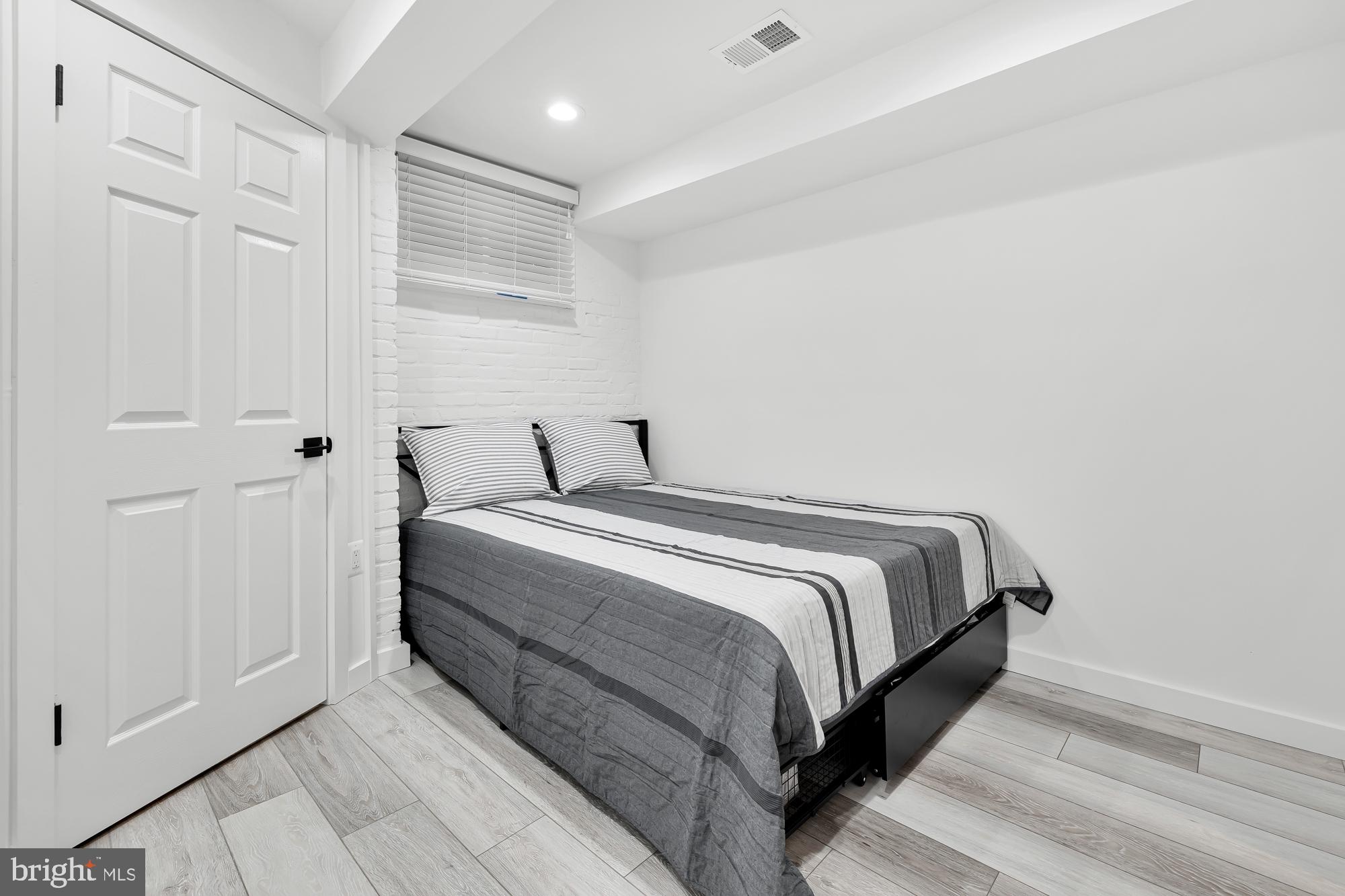 1821 19th Street Northwest, Unit 1 Washington, DC 20009 - Photo 17 of 24 a bedroom with a bed and a window