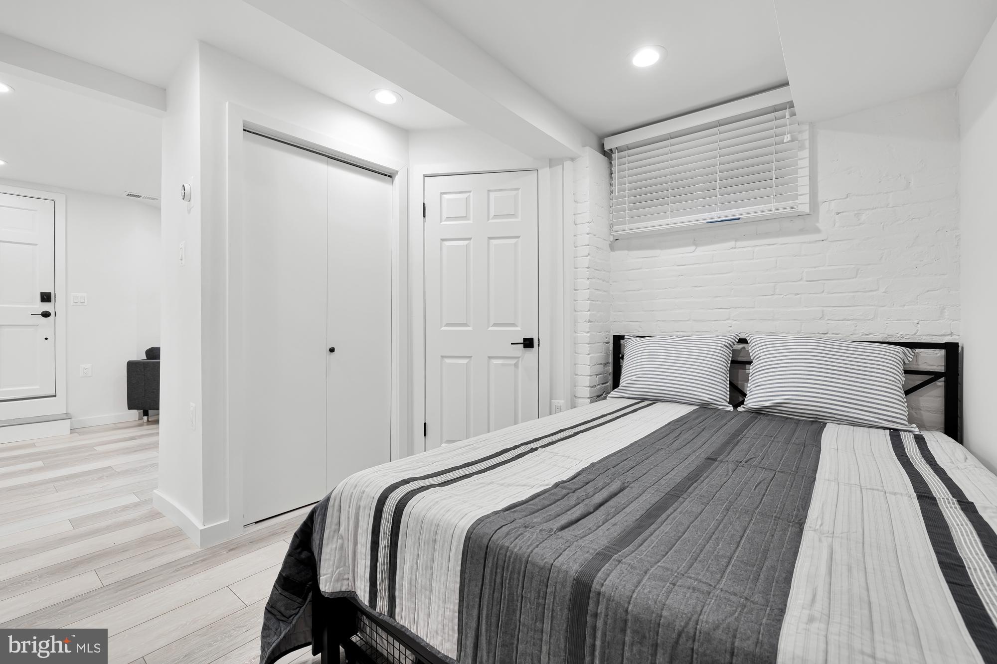 1821 19th Street Northwest, Unit 1 Washington, DC 20009 - Photo 19 of 24 a bedroom with a bed and a table