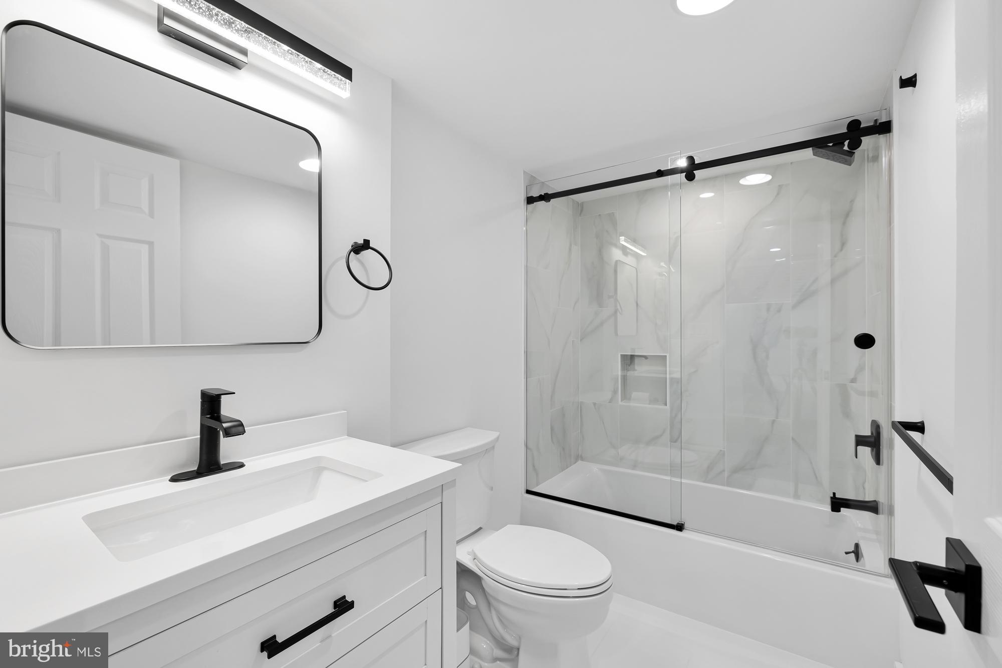 1821 19th Street Northwest, Unit 1 Washington, DC 20009 - Photo 21 of 24 a bathroom with a sink a toilet and a mirror