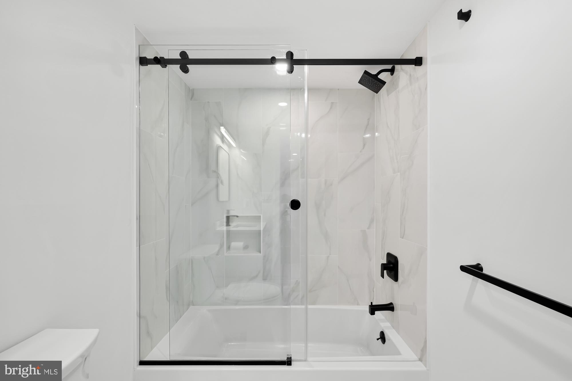 1821 19th Street Northwest, Unit 1 Washington, DC 20009 - Photo 22 of 24 a bathroom with a glass shower door