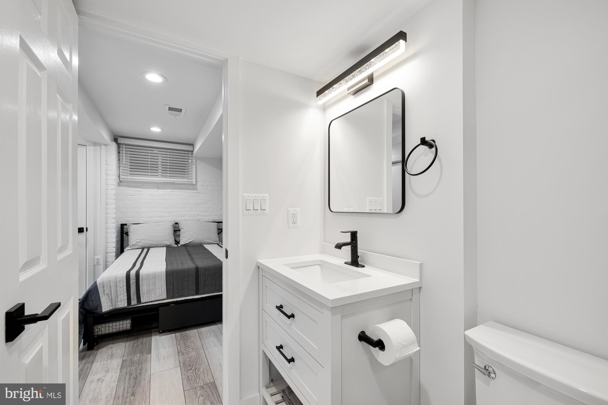 1821 19th Street Northwest, Unit 1 Washington, DC 20009 - Photo 23 of 24 a en suite bathroom with a double vanity sink and a mirror