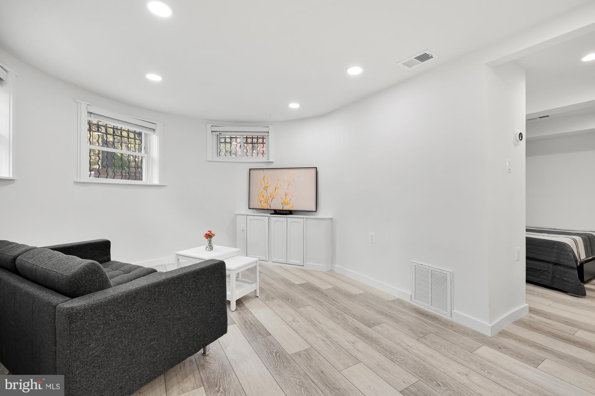1821 19th Street Northwest, Unit 1 Washington, DC 20009 - Photo 4 of 24 a living room with furniture and a wooden floor