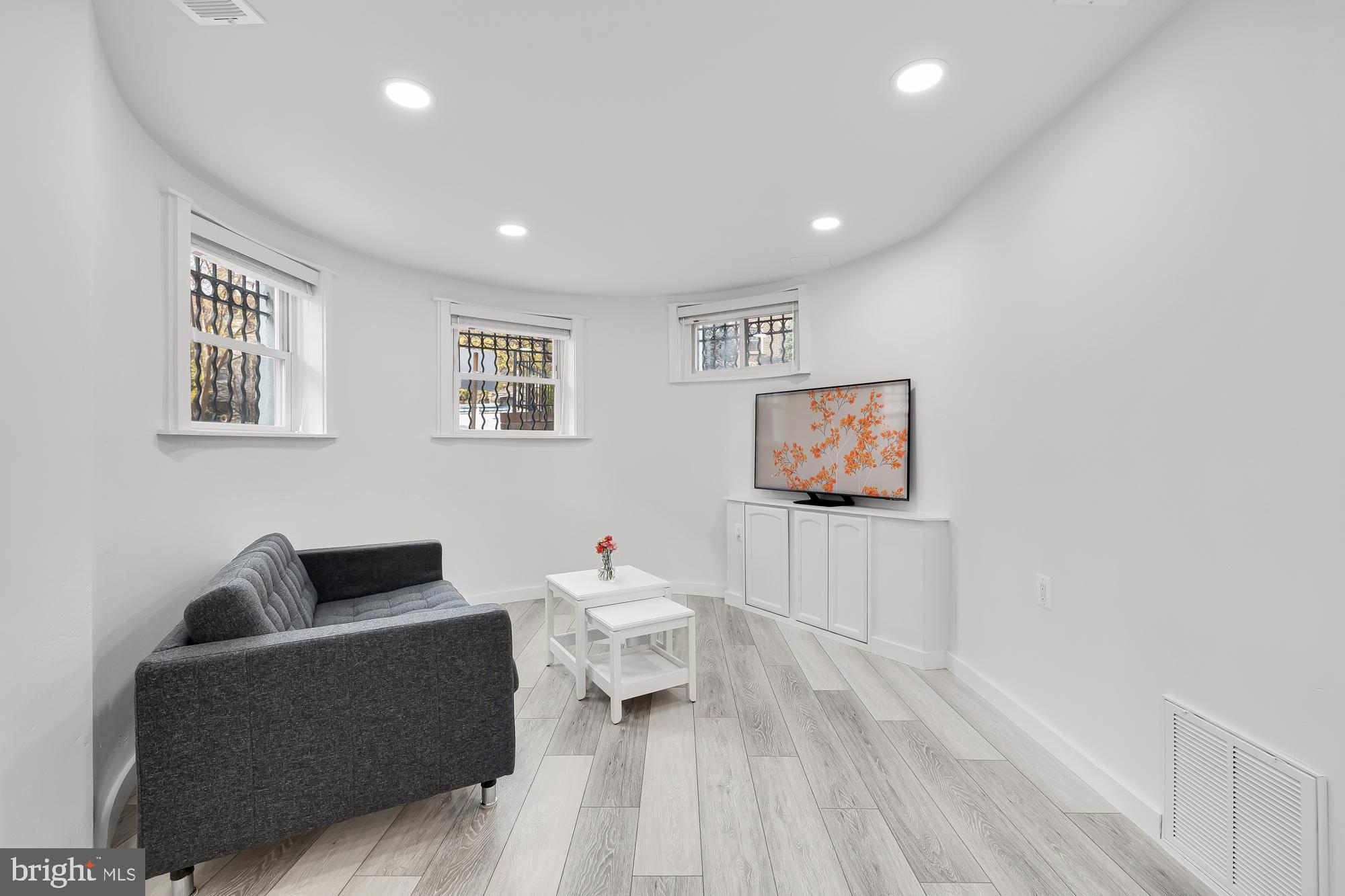 1821 19th Street Northwest, Unit 1 Washington, DC 20009 - Photo 5 of 24 a living room with furniture and a wooden floor