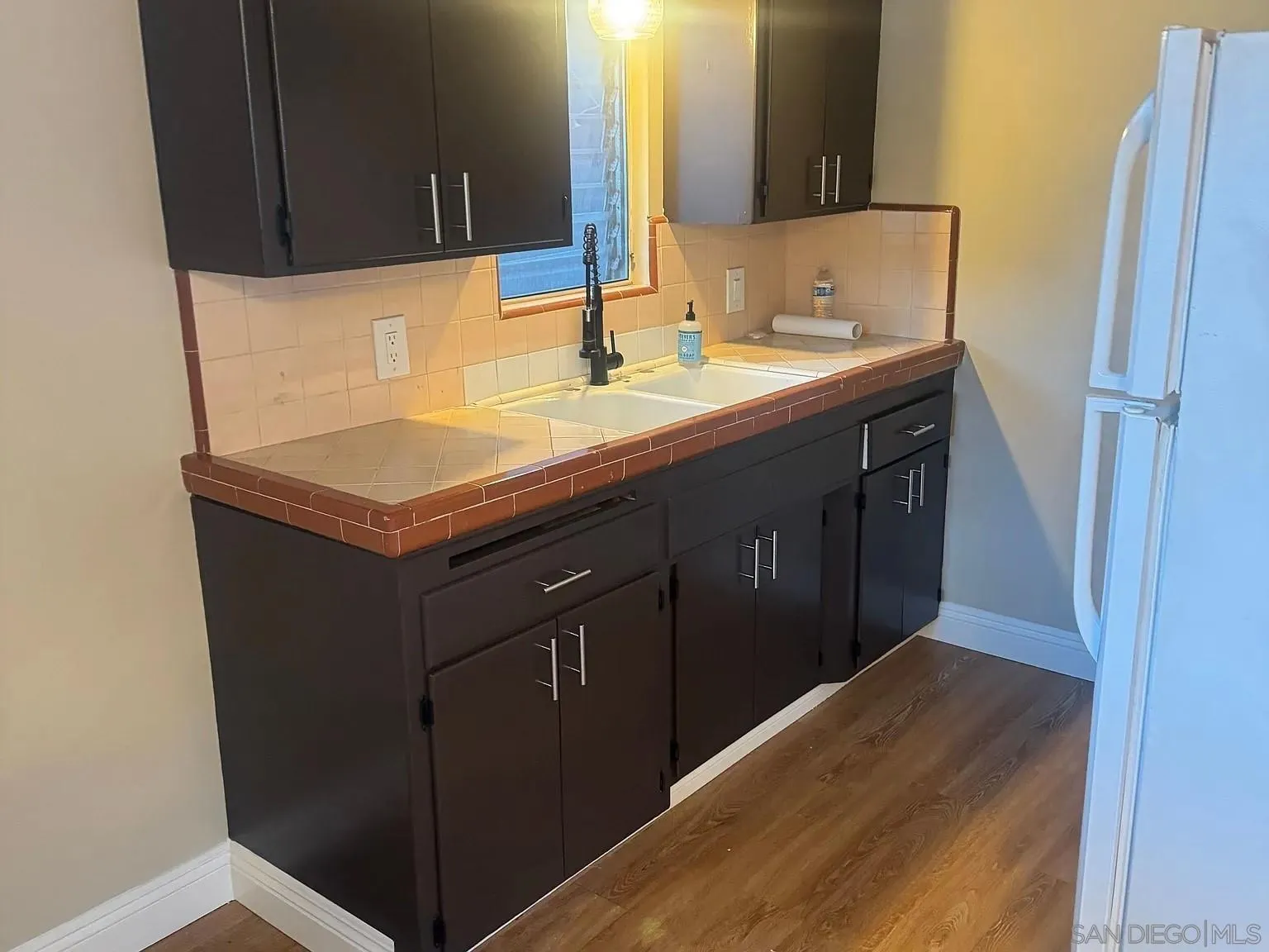 3206-16 Reynard Way San Diego, CA 92103 - Photo 8 of 12 a bathroom with a sink and a mirror