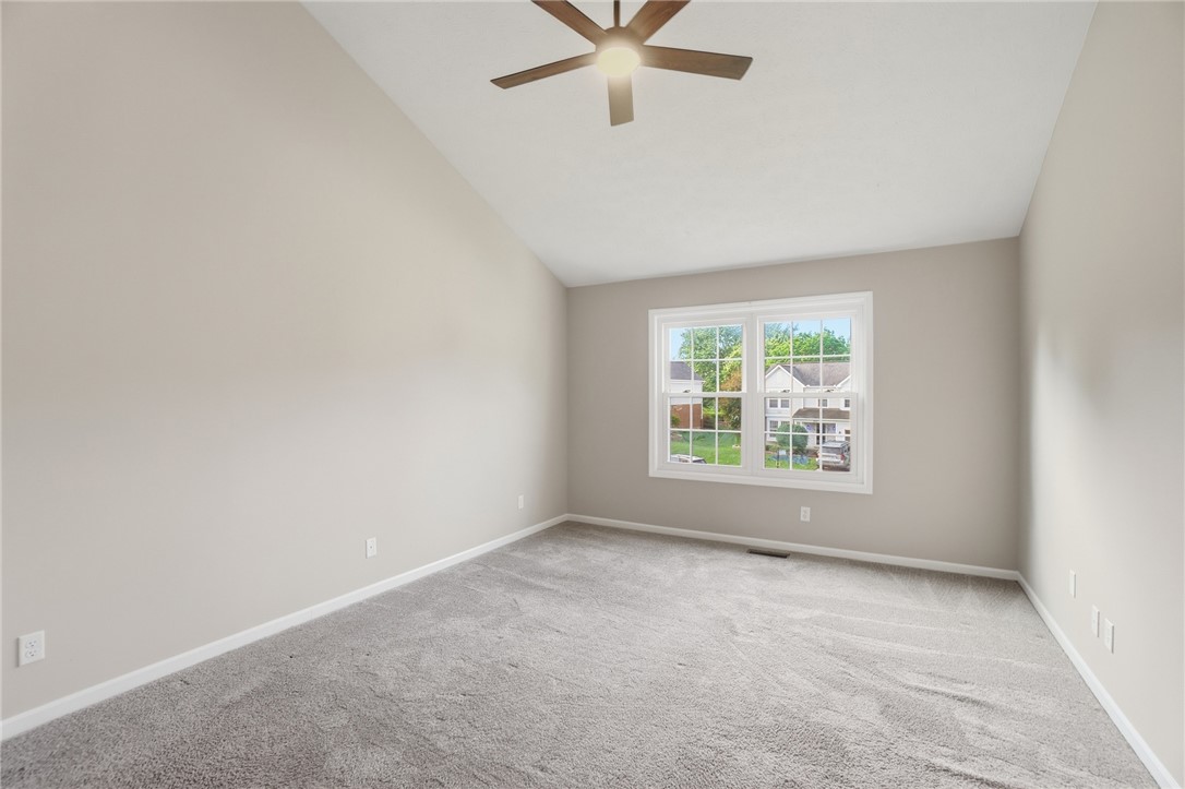 10 Chase Court Springboro, OH 45066 - Photo 33 of 75 This spacious bedroom offers high vaulted ceilings and plush carpet, creating a serene and inviting atmosphere.
