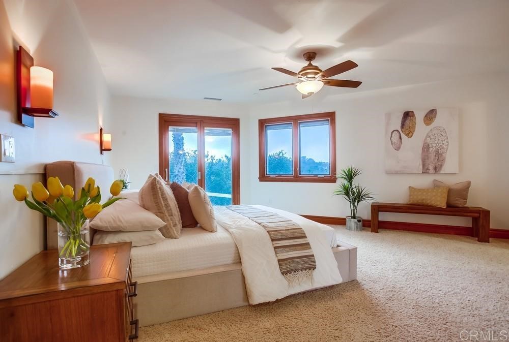840 Highland Drive Solana Beach, CA 92075 - Photo 18 of 24 a bedroom with bed and a chandelier