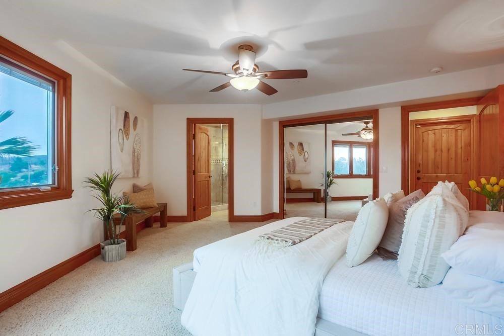 840 Highland Drive Solana Beach, CA 92075 - Photo 19 of 24 a bedroom with a bed and a chandelier