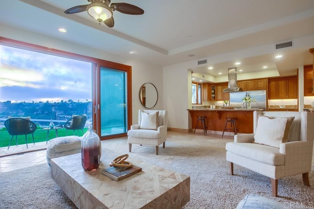 840 Highland Drive Solana Beach, CA 92075 - Photo 10 of 24 a living room with kitchen view and a floor to ceiling window