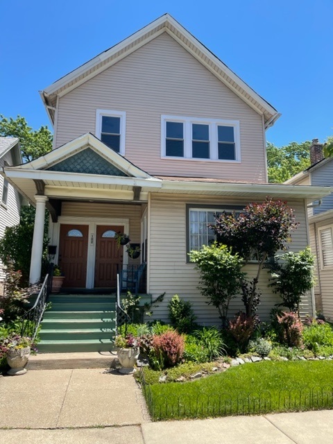 122 Elgin Avenue, Unit 2 Forest Park, IL 60130 - Photo 1 of 10 a front view of a house with a yard