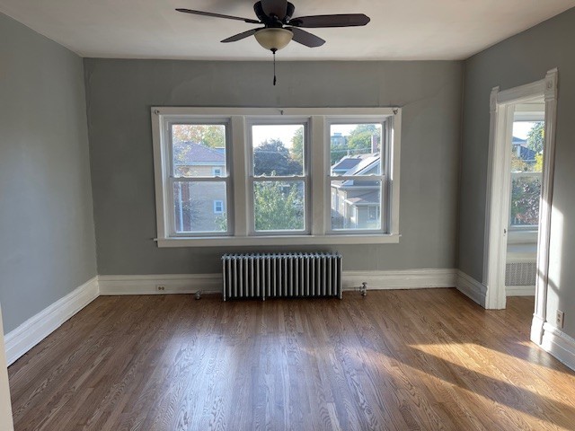 122 Elgin Avenue, Unit 2 Forest Park, IL 60130 - Photo 3 of 10 an empty room with wooden floor and windows
