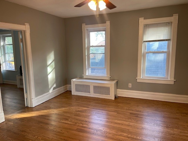 122 Elgin Avenue, Unit 2 Forest Park, IL 60130 - Photo 7 of 10 an empty room with wooden floor cabinet and windows