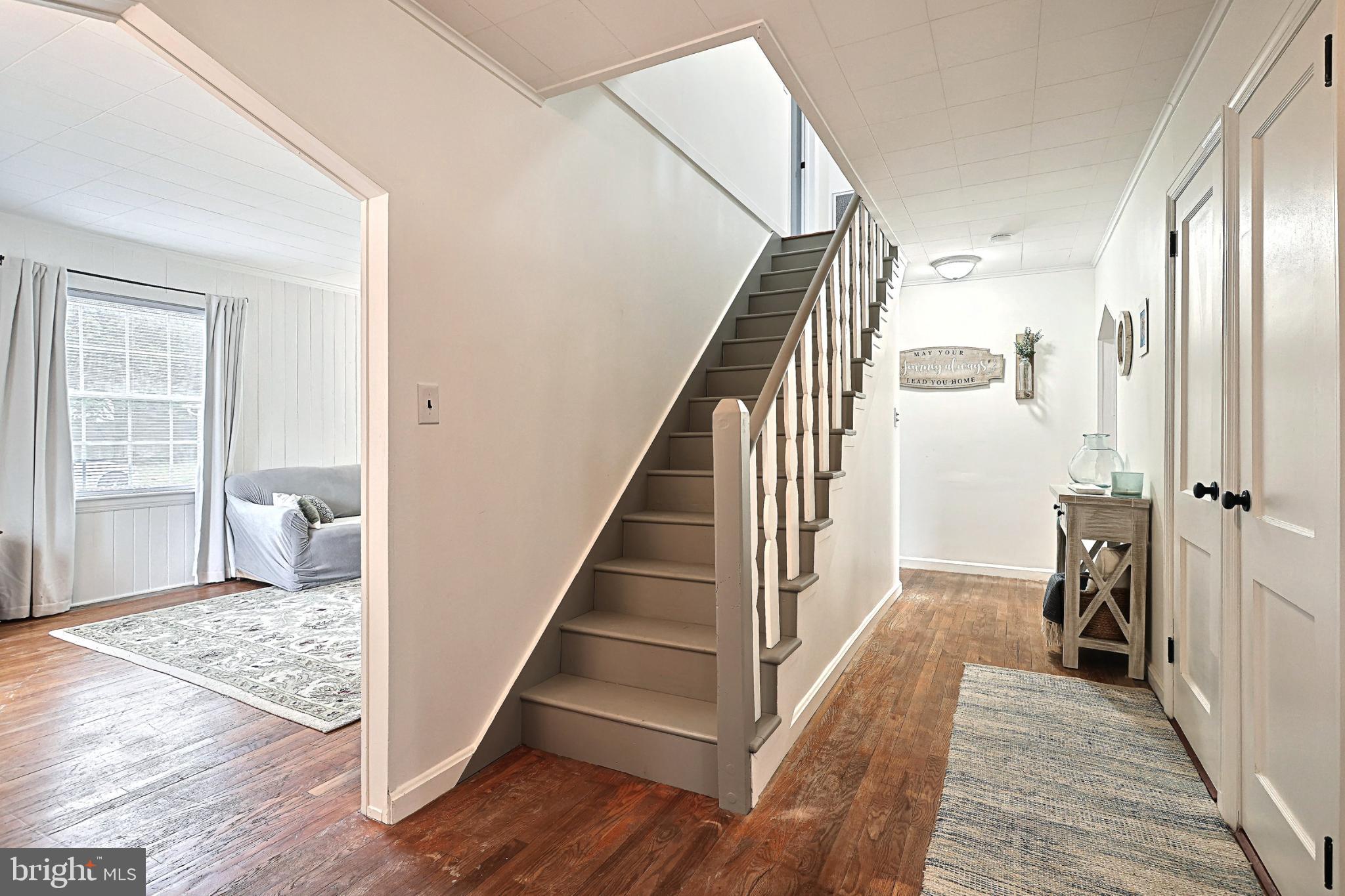 6927 York Road Abbottstown, PA 17301 - Photo 12 of 41 a view of a hallway with wooden floor and staircase